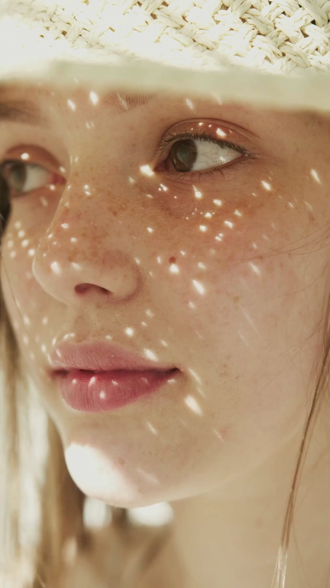 Close-up of a woman highlighting her healthy, youthful skin with a natural glow, showcasing the effects of Karin Herzog skincare.